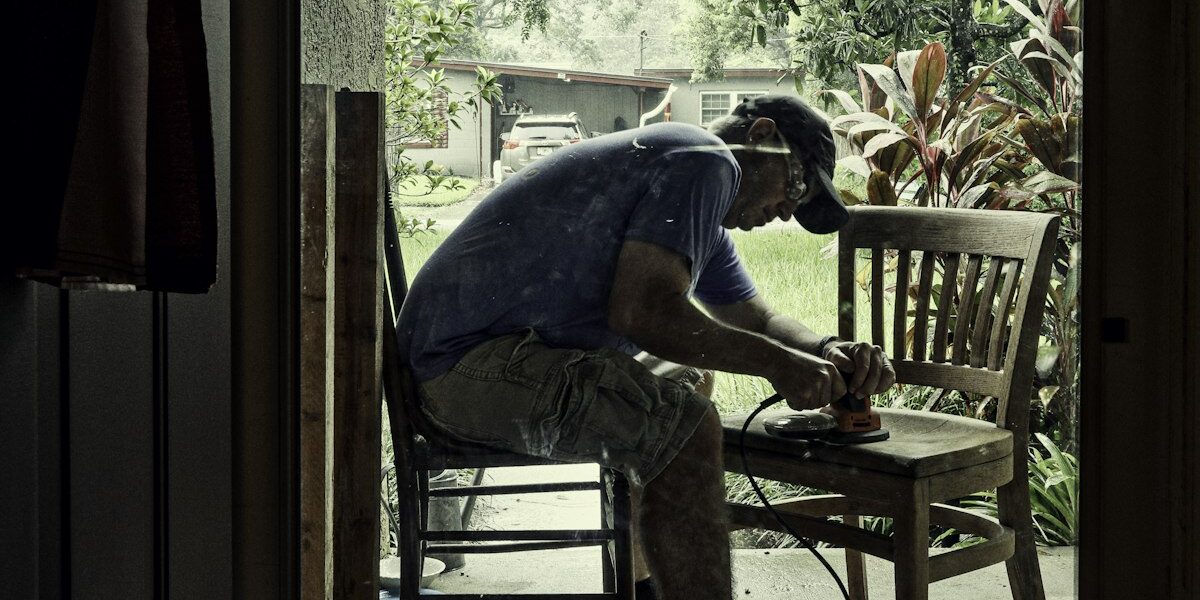 Palm sander being used on furniture